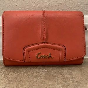 Coral Coach leather wallet with tan interior